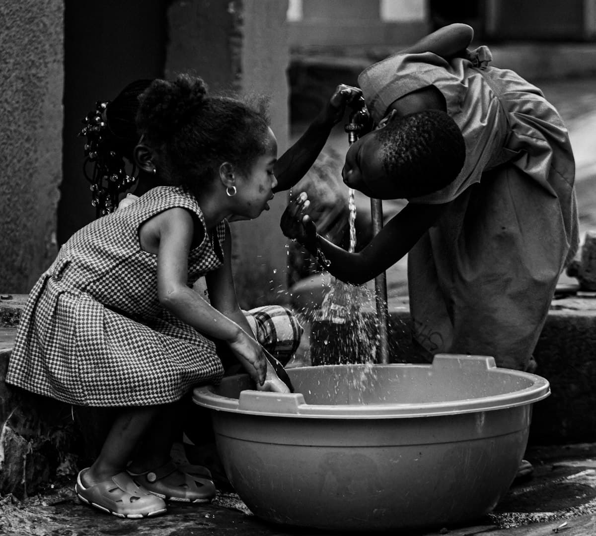 Children washing at a water tap (representative photo, Kampala, Uganda)