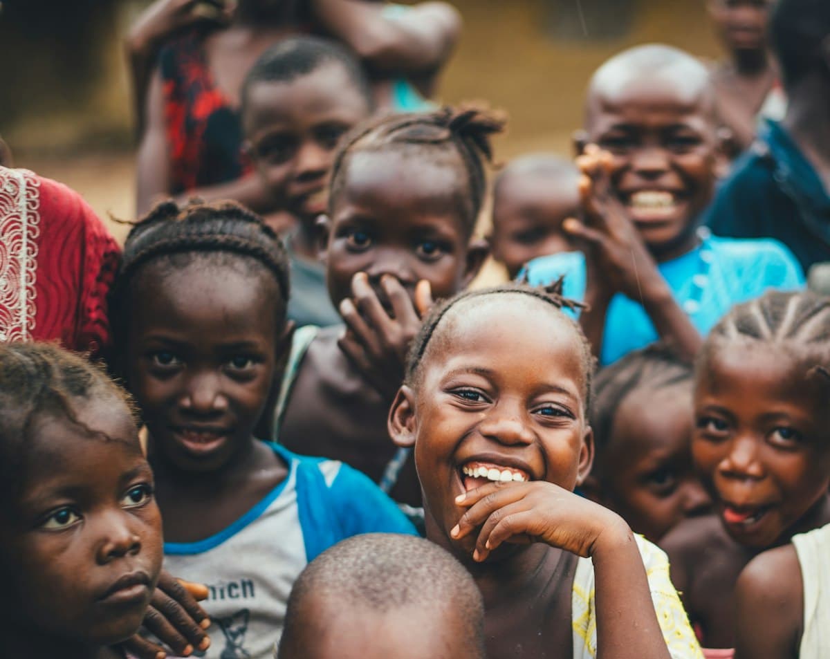 Children laughing together at a community gathering in Sierra Leone, West Africa